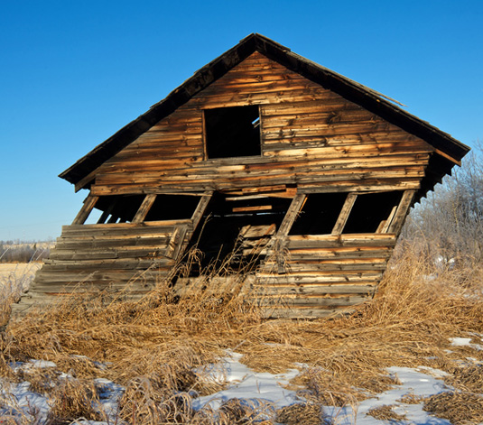 A run-down barn that leans over.  The rectangular doorway and square windows are now pushed over.
