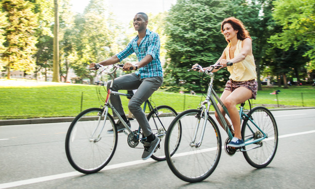 Two people riding bicycles.