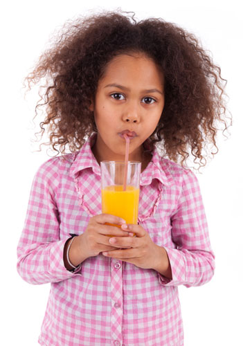 A girl drinking orange juice.