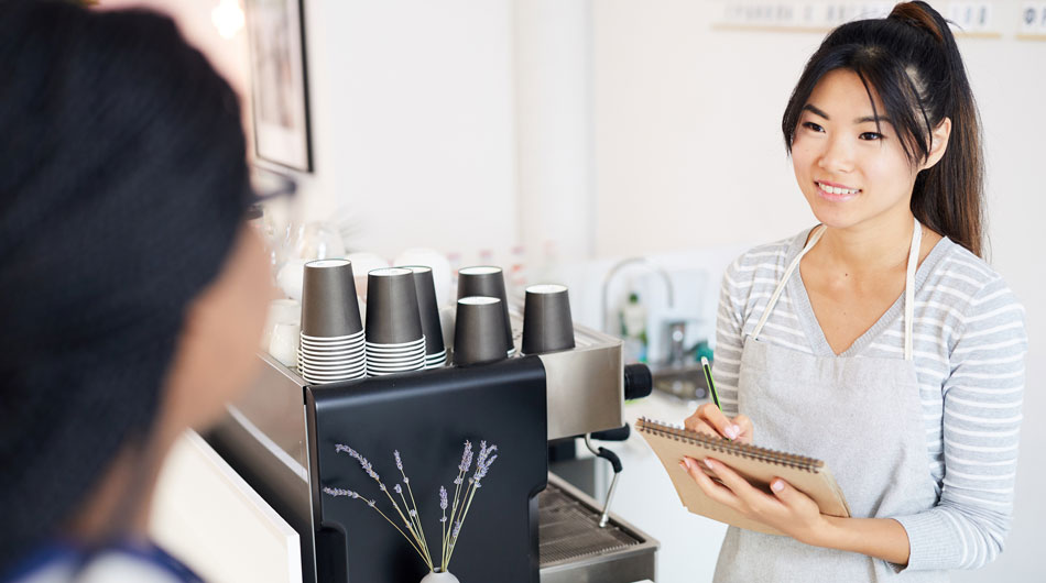A waitress taking a coffee order.