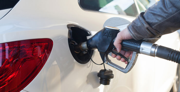 Filling up a car at a gas station.