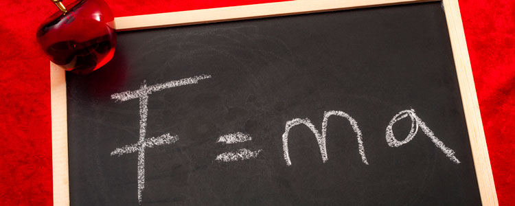 On a chalkboard, the formula F = m times a is written.