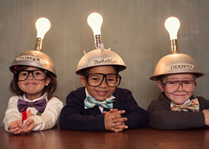Children with light-bulb helmets on their heads.