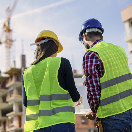 Two construction workers looking at plans