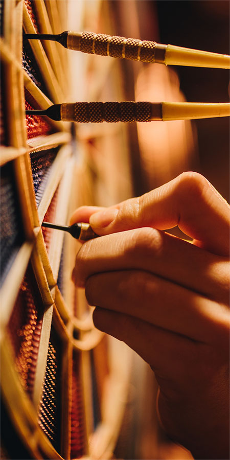Close-up of darts in a dartboard