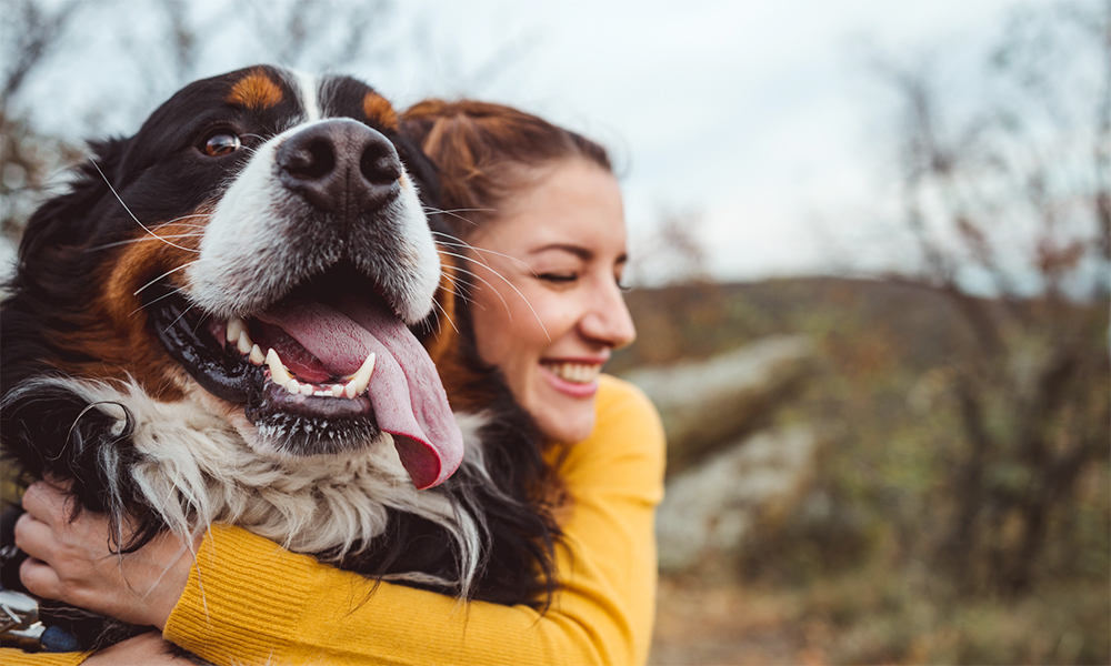 A woman hugging her dog.
