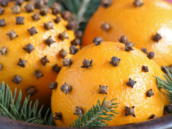 Oranges with cloves pushed into the skin.