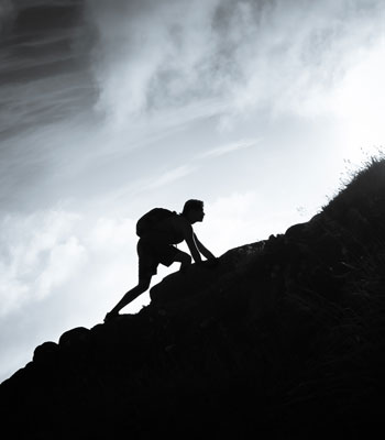 A man climbing a mountain.