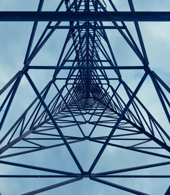 Looking up at a communications tower from the base.