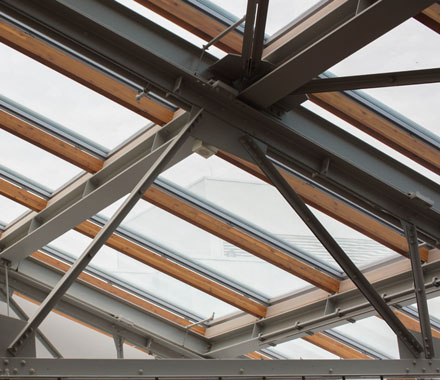 The triangular truss of a building.