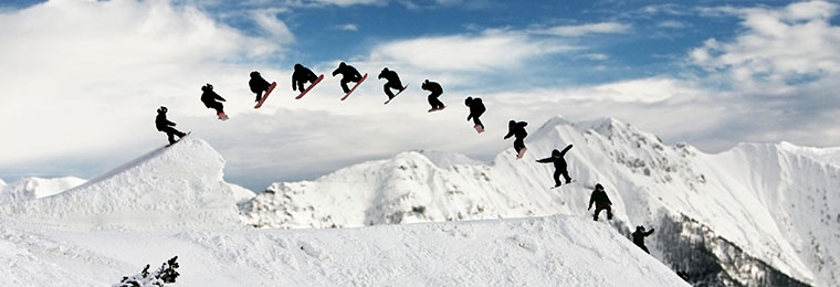 A sequenced photo showing a snowboarder turning around 360 degrees while jumping.