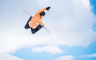 Snowboarder doing a trick during a jump.
