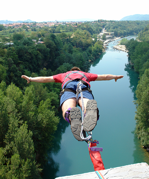 A man bungee jumping off a bridge